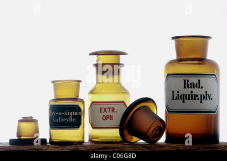 Old medicine bottles on a wooden shelf Stock Photo