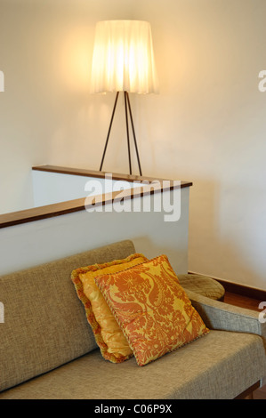 Vintage sofa with pillows and lamp Stock Photo