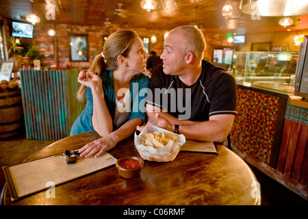A couple in their 30's seem to be having an unhappy date at a California restaurant. MODEL RELEASE Stock Photo