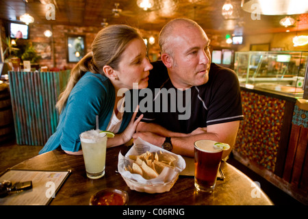 A couple in their 30's seem to be having an unhappy date at a California restaurant. MODEL RELEASE Stock Photo