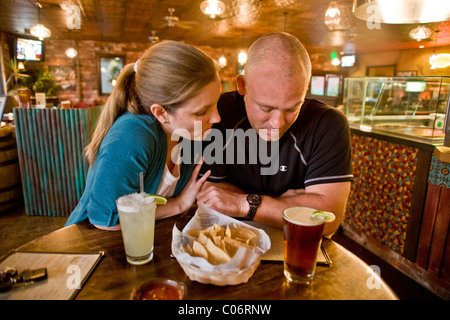 A couple in their 30's seem to be having an unhappy date at a California restaurant. MODEL RELEASE Stock Photo