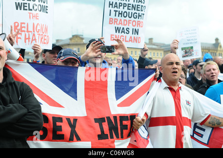 EDL supporters sing England songs and raise there banners and flags at the UAF crowd Stock Photo