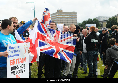 EDL supporters hold there flags and sing England songs Stock Photo