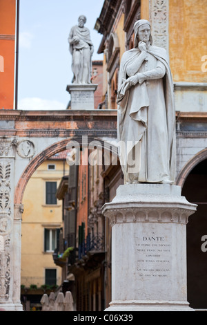 statue of Dante Alighieri in front of historic facade in Verona, Italy Stock Photo