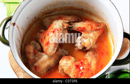 Marinated chicken wings in a pot - overhead Stock Photo