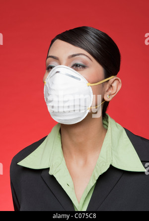 Businesswoman wearing a pollution mask Stock Photo