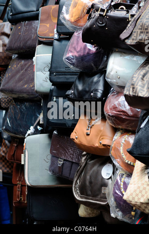 fake designer leather bags handbags pirate pirated luxury goods on sale stall petaling street chinatown kuala lumpur malaysia Stock Photo