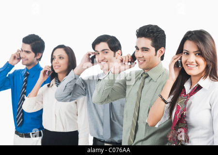 Business executives talking on mobile phones Stock Photo