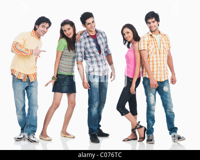 Image of a group of cheerful Asian college students putting their hands ...