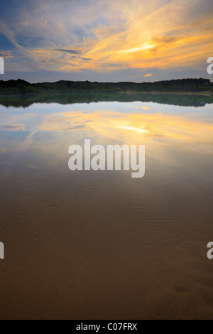 Lake in dunes at sunset. Stock Photo