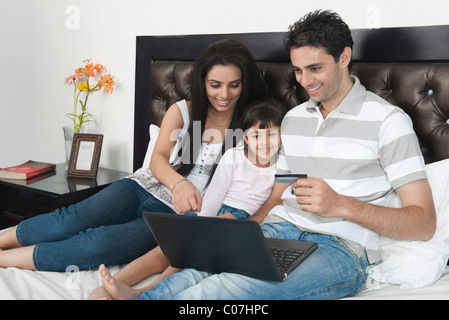 Man doing online shopping with his family Stock Photo