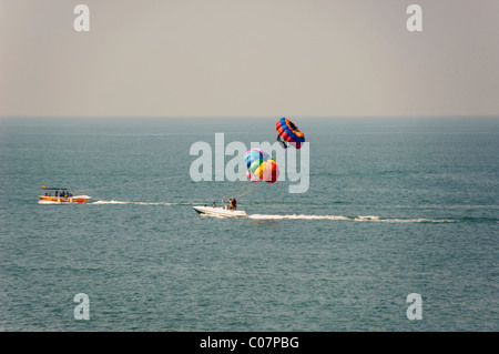 Tourists parasailing in the sea, Goa, India Stock Photo