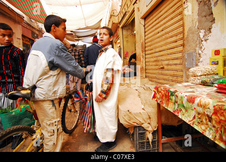 Algeria. Ghardaia, view of marketplace with vegetable sellers, man selling plastic bags in the foreground Stock Photo