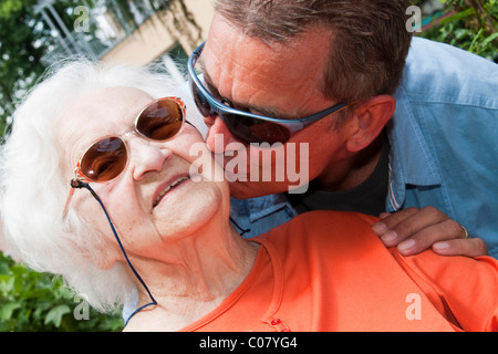 97 year old nursing home resident receiving affection Stock Photo
