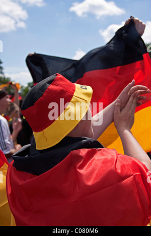 German soccer fans attending the public screening in front of the Olympic Stadium during the FIFA World Cup 2010, watching the Stock Photo