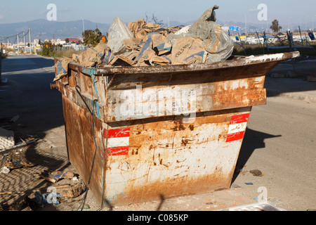 Skip full of building refuse. Malaga, Malaga Province, Spain. Stock Photo