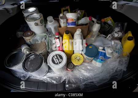 Containers of toxic and hazardous household chemicals being taken to designated recyclers Stock Photo