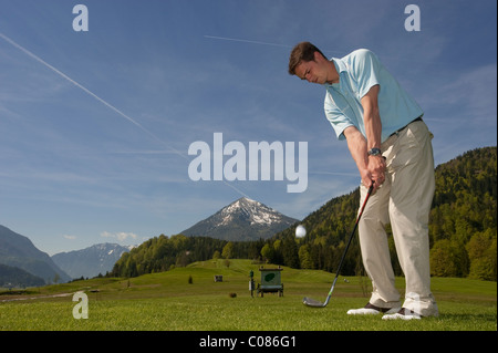 Golf player chipping on alpine golf course, Achenkirch, Tyrol, Austria, Europe Stock Photo