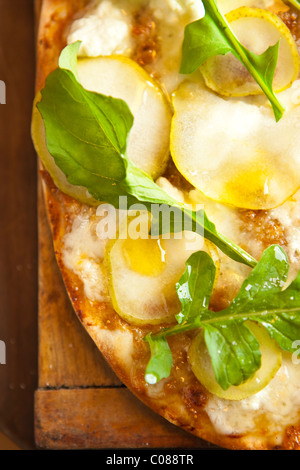 Thin and crispy crust Pizza with Mozzarella, Goat Cheese, Fig Spread, Pear and Arugula prepared by Gianni Scappin, Chef/Owner of Stock Photo