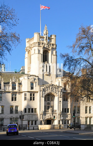 Union Flag flying on clear blue sunny day above tower of old Middlesex Guildhall building now UK Supreme court in Parliament Square London England UK Stock Photo