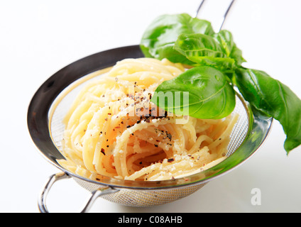 Spaghetti sprinkled with cheese and vegetable mix Stock Photo