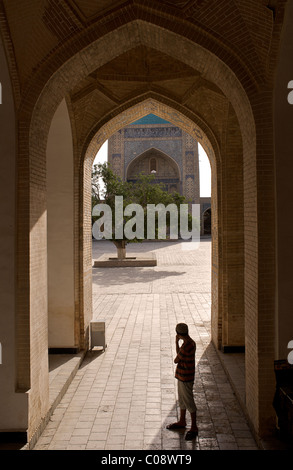 Silhouette of Uzbeki teenager in the Kalon Mosque, Bukhara, Uzbekistan Stock Photo