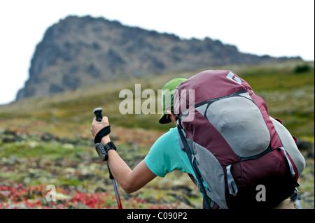 Female backpacker hiking to Ptarmigan Pass, Chugach State Park, Southcentral Alaska, Summer Stock Photo