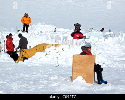 Female climber uses the latrine at Camp Three on the West Buttress Route, Kahiltna Glacier on Mt. McKinley, Denali National Park Stock Photo