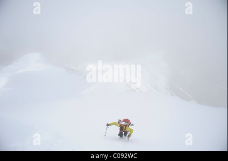 Backpacker climbs the West Ridge of Mt. Chamberlin in the Brooks Range, ANWR, Arctic Alaska, Summer Stock Photo
