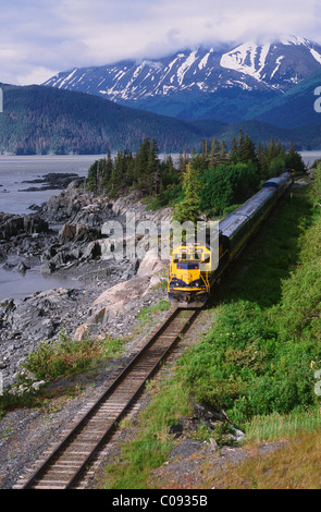 View from the Seward Highway of an Alaska Railroad passenger train near Bird Point along Turnagain Arm, Southcentral Alaska Stock Photo