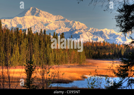 View of southside Mount McKinley at sunrise with small lake in foreground, Southcentral Alaska, Autumn, HDR image Stock Photo