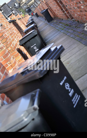 Wheelie bins in a traditional British back alley Stock Photo