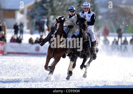 Polo players battling for the ball, Steffi von Pock of Team Parmigiani against Thomas Wolfensberger of Team Valartis Group, Snow Stock Photo