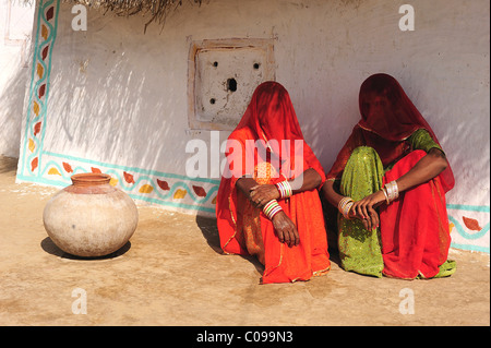 Veiled women talking in front of their house, Thar Desert, Rajasthan, North India, India, Asia Stock Photo