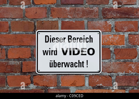 Sign on brick wall, 'Dieser Bereich wird VIDEO ueberwacht!', German for 'this area is under video surveillance' Stock Photo