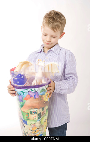 Boy looking at large cornet of cardboard filled with sweets and little presents given to children in Germany on their first day Stock Photo