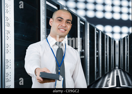 Portrait of a technician smiling in a server room Stock Photo
