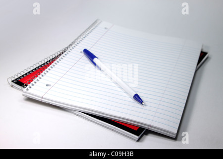 Spiral bound notebook open with pen Stock Photo