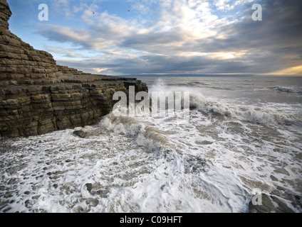 Waves breaking against the rocky Heritage Coast, south Wales Stock Photo