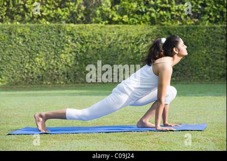 Woman doing Surya Namaskar (Sun Slautation) Stock Photo