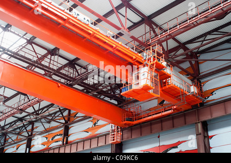 Large-tonnage industrial orange Goliath crane loading of goods in factory mill in Russia Stock Photo