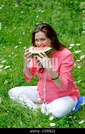 Pregnant woman eating watermelon at garden Stock Photo - Alamy