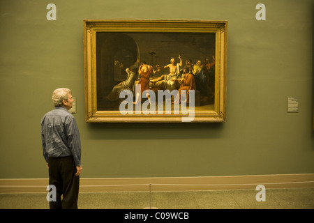 Museum goer ponders 'The Death OF Socrates' (1787) by David at the Metropolitan Museum Of Art in New York City. Stock Photo