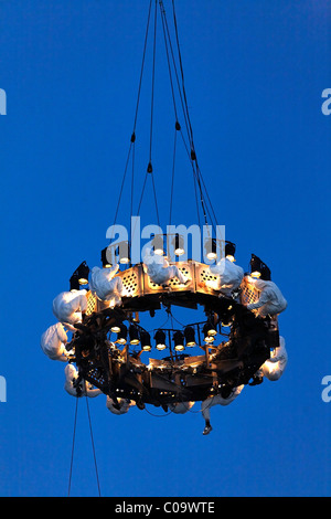 White-clad trapeze artists hanging upside down from a platform in the air, Global Rheingold, open-air theater by La Fura dels Stock Photo