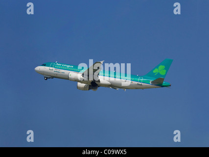 Passenger plane of the Irish airline Aer Lingus, Airbus A320-214, climb against blue sky Stock Photo