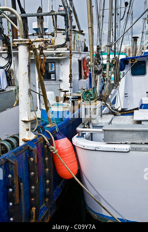 Abstract image of two fishing vessels moored together at a wharf