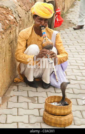 A man charming a snake outside the walls of the Amber Fort in Jaipur. Stock Photo