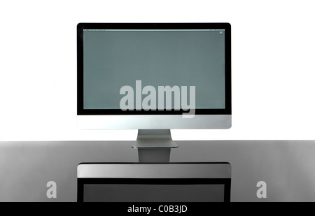 Elegant wireless computer isolated on a glass desk with a white background. Front View. Stock Photo