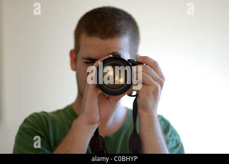 Photographer focusing camera. Stock Photo