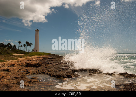 Large wave crashing into rocky coast. Barber's Point Lighthouse, Oahu Hawaii. Stock Photo